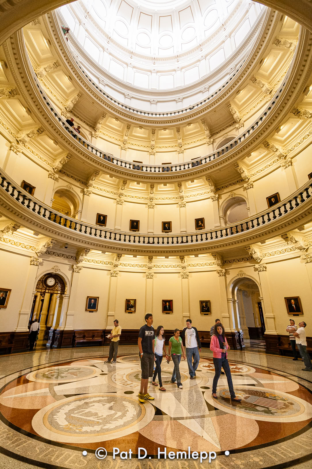 Visitors walk through the rotunda under the dome of the Texas capitol building in Austin, Texas.